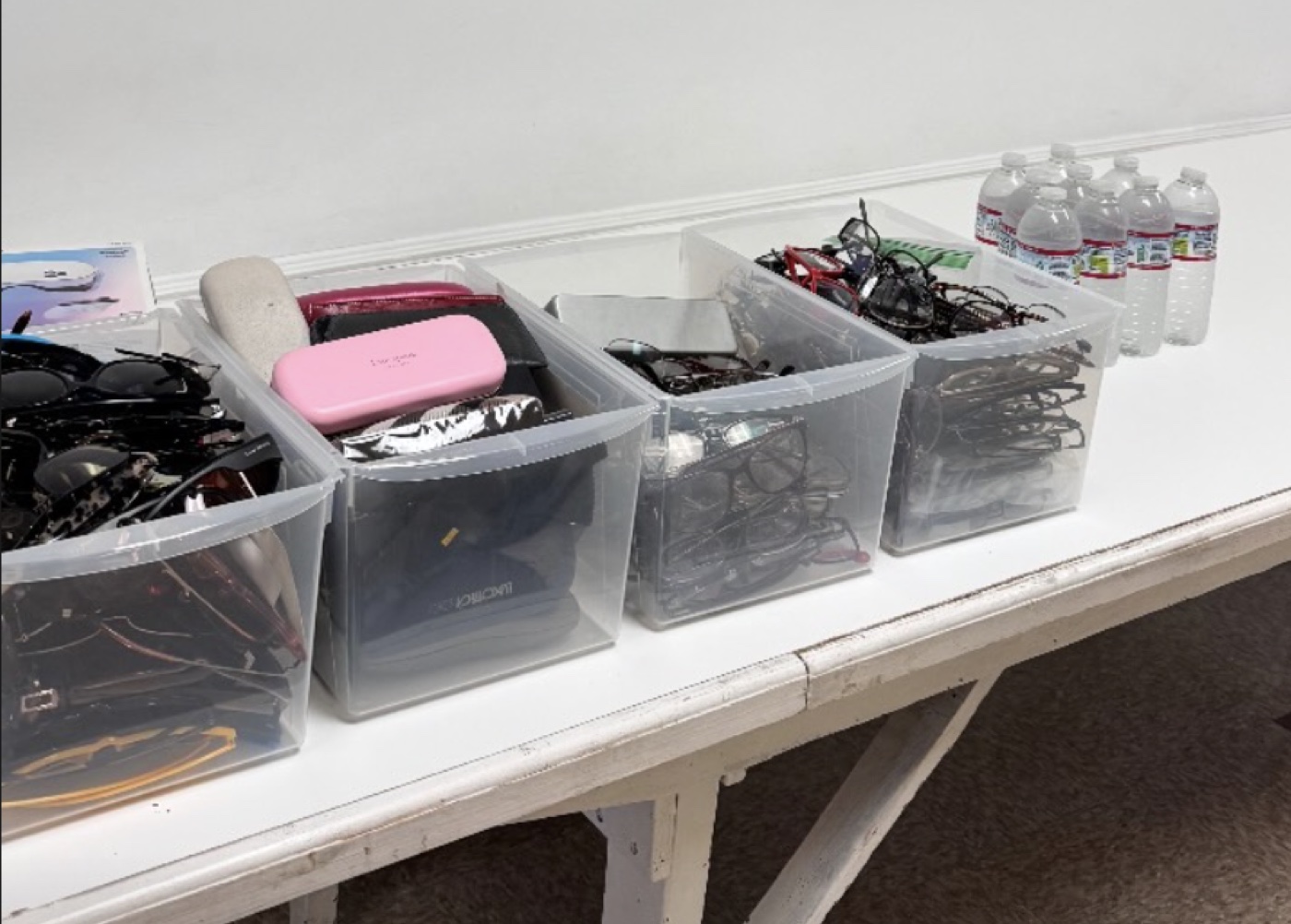 Bins of collected eyeglasses organized for donation